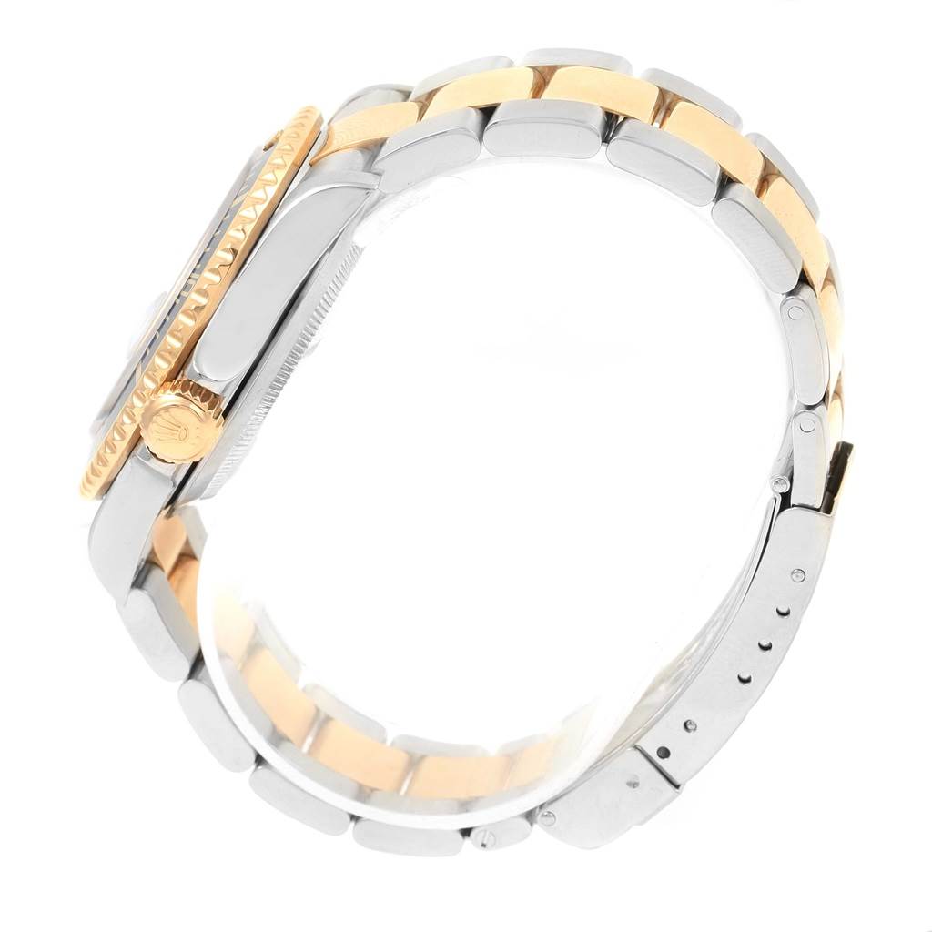 This side view of the Rolex Submariner 16613 Men's Steel and Gold (two tone) Blue Dial 16613 Men's Steel and Gold (two tone) Blue Dial watch shows the two-tone metal bracelet and the crown.