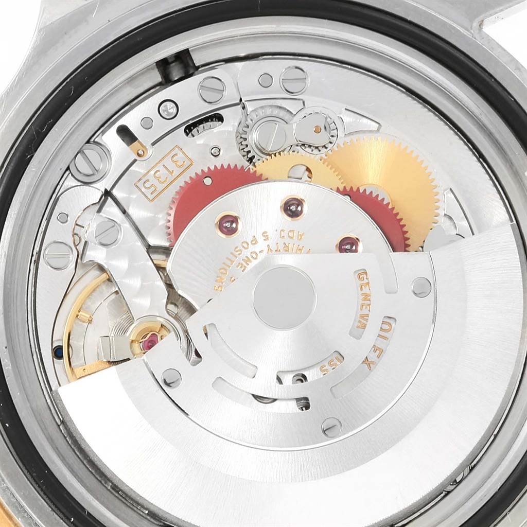 The image shows an internal view of the Rolex Submariner 16613 Men
s Steel and Gold (two tone) Grey Dial 16613 Men
s Steel and Gold (two tone) Grey Dial
s watch movement and gears from a rear angle.
