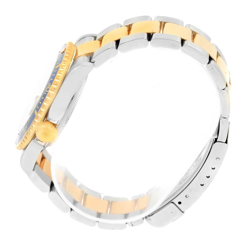 This image shows the side view of a Rolex Submariner 16613 Men
s Steel and Gold (two tone) Grey Dial 16613 Men
s Steel and Gold (two tone) Grey Dial watch, highlighting the gold crown and stainless steel bracelet with gold inlay.