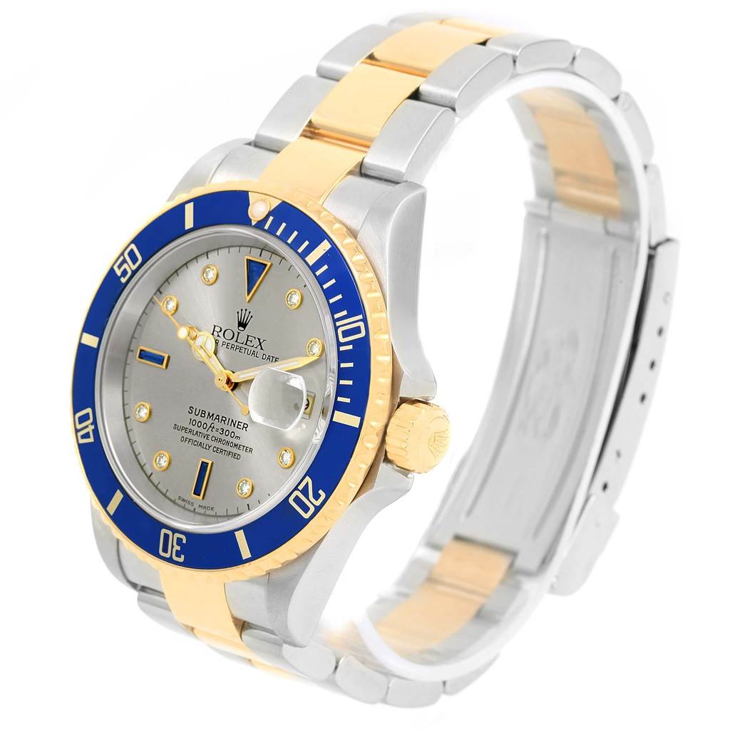 The image shows a Rolex Submariner 16613 Men
s Steel and Gold (two tone) Grey Dial 16613 Men
s Steel and Gold (two tone) Grey Dial watch at a three-quarter angle, highlighting the bezel, dial, and partially the bracelet.