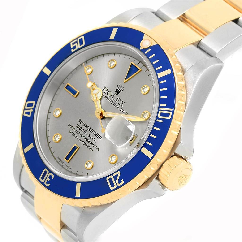 This image shows a close-up of the Rolex Submariner 16613 Men
s Steel and Gold (two tone) Grey Dial 16613 Men
s Steel and Gold (two tone) Grey Dial watch, highlighting the face, bezel, and part of the bracelet.