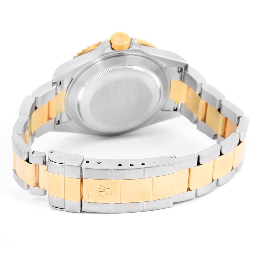 The image shows the back case and bracelet clasp of a Rolex Submariner 16613 Men
s Steel and Gold (two tone) Grey Dial 16613 Men
s Steel and Gold (two tone) Grey Dial watch at an angled rear view.