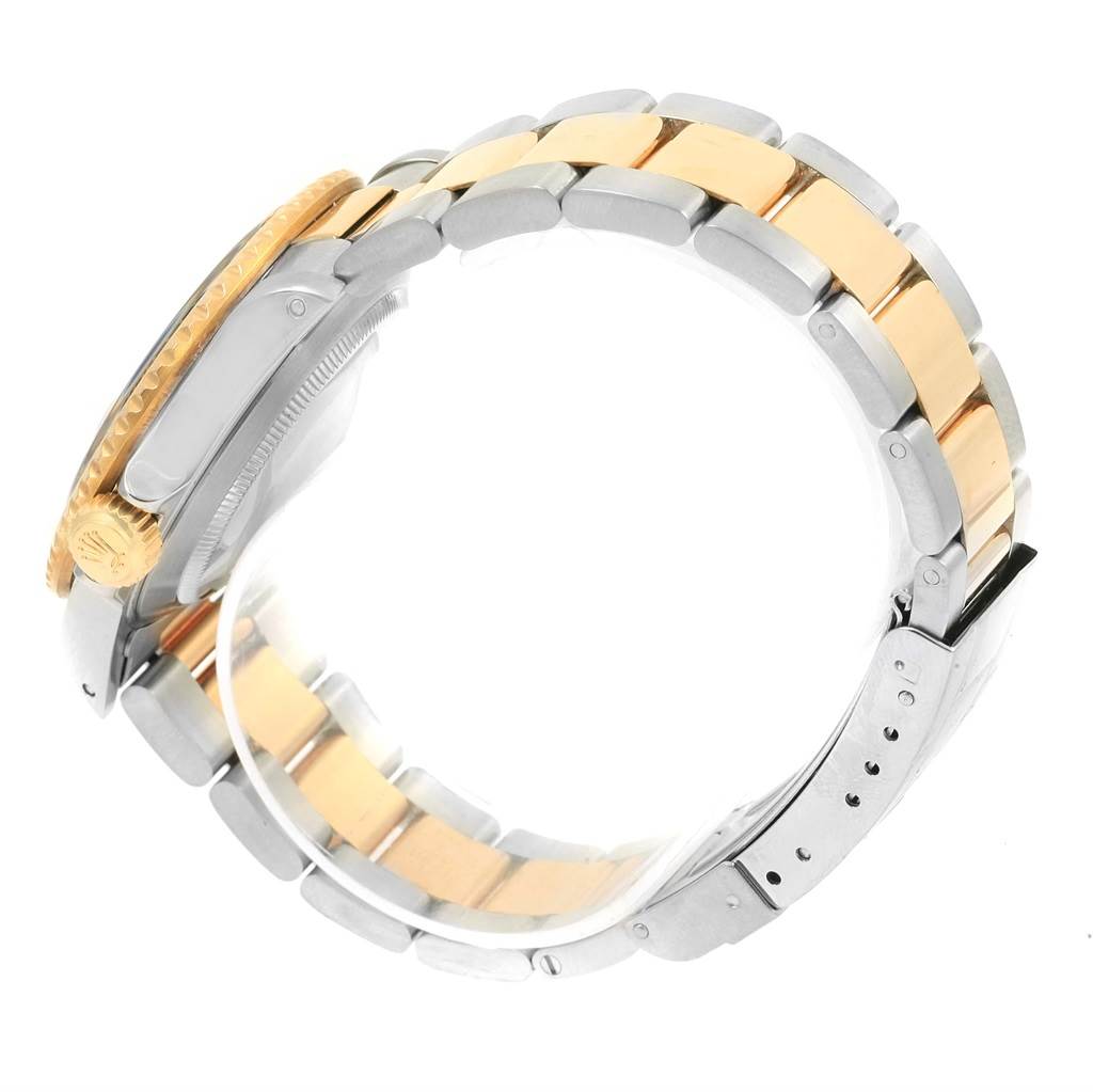 The image shows a side view of a Rolex Submariner 16613 Men
s Steel and Gold (two tone) Black Dial 16613 Men
s Steel and Gold (two tone) Black Dial watch, focusing on its two-tone bracelet and crown.