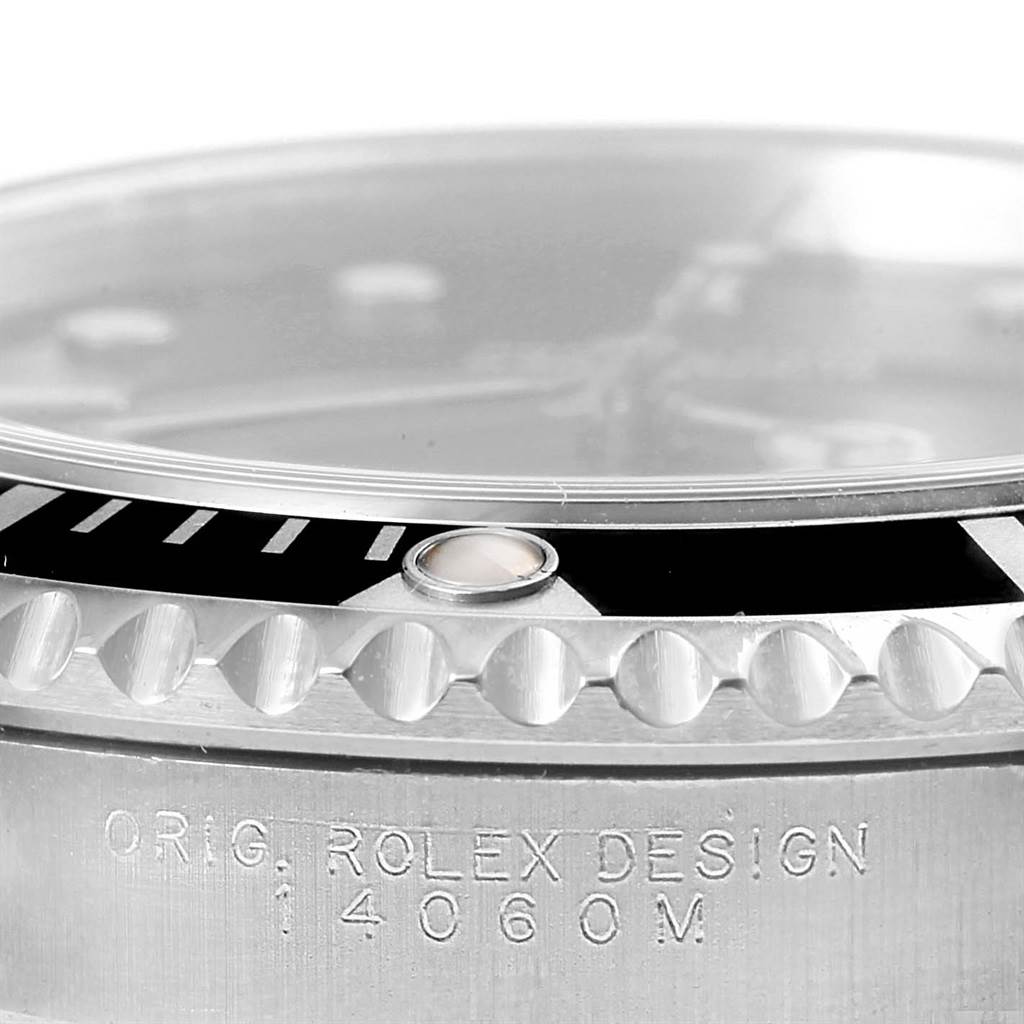 This image shows a close-up of the bezel and sides of a Rolex Submariner 14060 Men's Stainless Steel Black Dial 14060 Men's Stainless Steel Black Dial watch, highlighting the "ROLEX DESIGN" engraving.