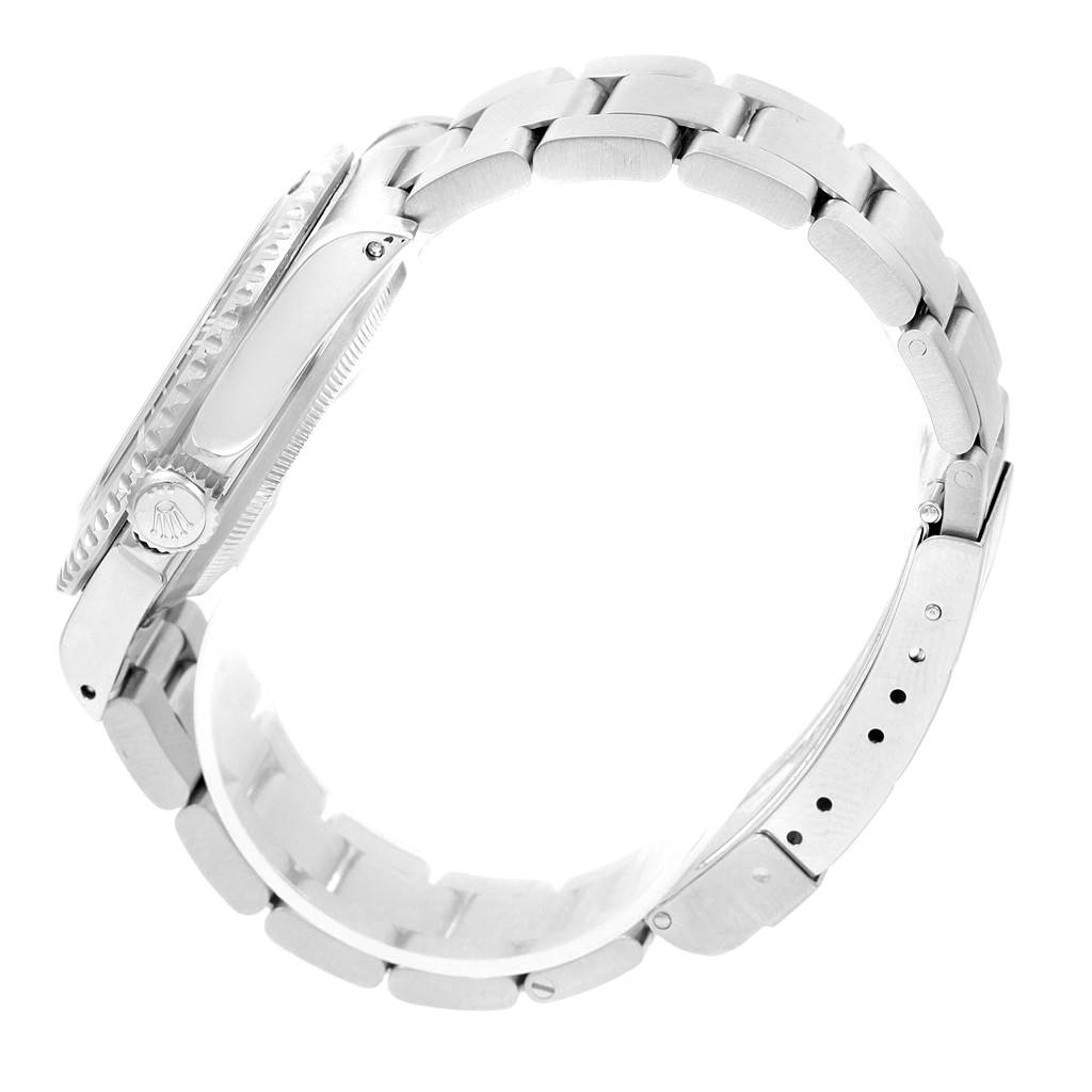 This side view of a Rolex Submariner 14060 Men's Stainless Steel Black Dial 14060 Men's Stainless Steel Black Dial watch displays its case, crown, bezel, and bracelet links.