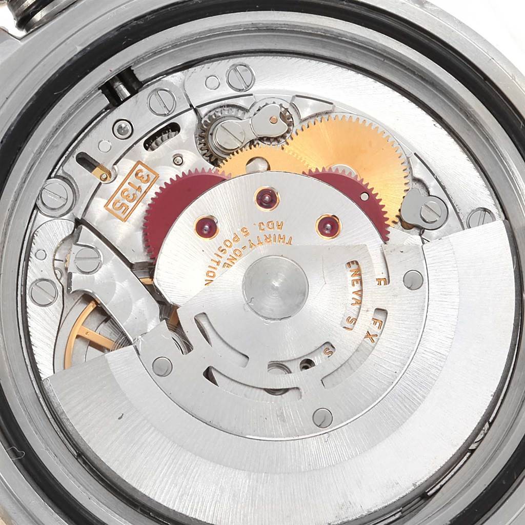 The image shows a close-up of the internal mechanism of a Rolex Submariner 16613 Men
s Steel and Gold (two tone) Champagne Dial 16613 Men
s Steel and Gold (two tone) Champagne Dial watch, focusing on gears and rotors.