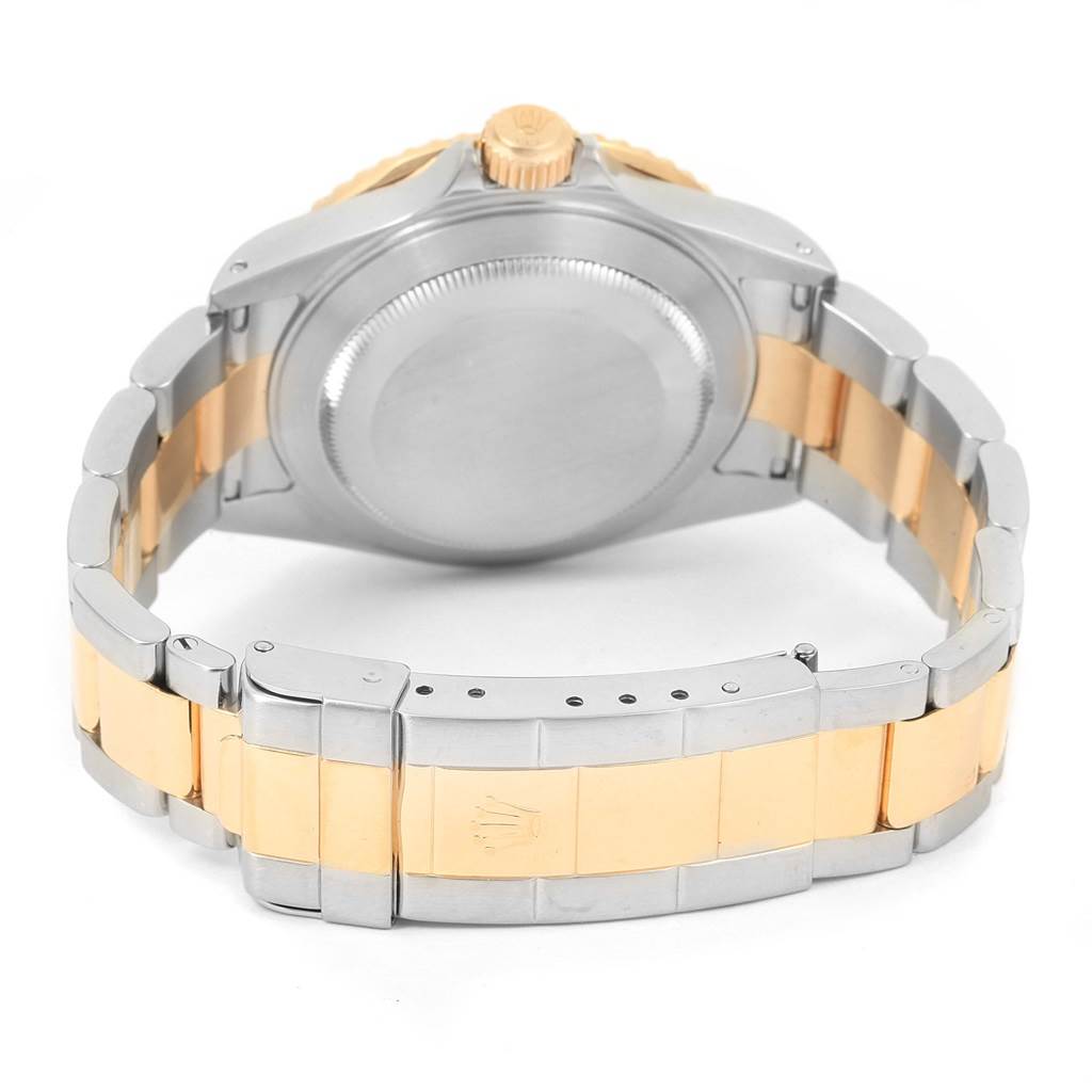 The image shows the back case and bracelet of a Rolex Submariner 16613 Men
s Steel and Gold (two tone) Champagne Dial 16613 Men
s Steel and Gold (two tone) Champagne Dial watch, featuring a two-tone metal design.