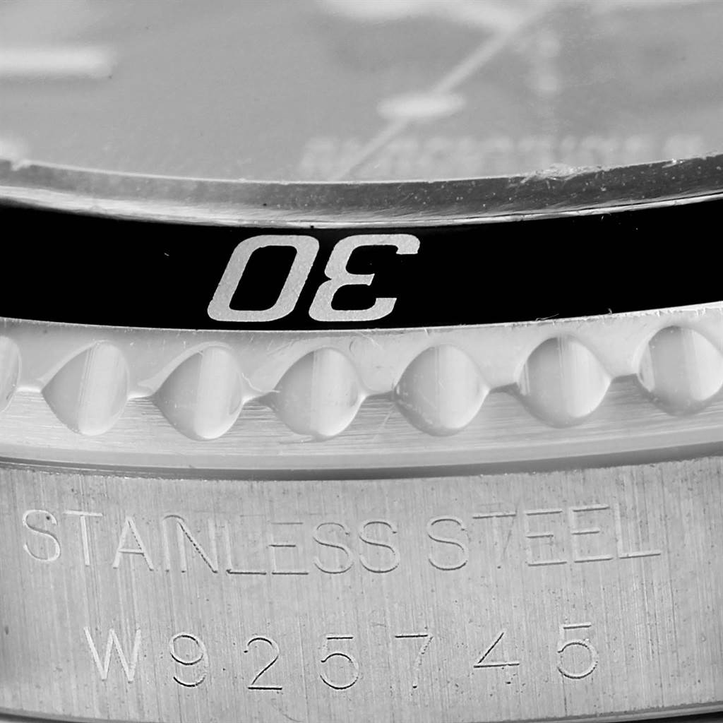 Close-up view of the bezel and engraved edge of a Rolex Submariner 14060 Men
s Stainless Steel Black Dial 14060 Men
s Stainless Steel Black Dial watch, showing the number "30" and "STAINLESS STEEL."