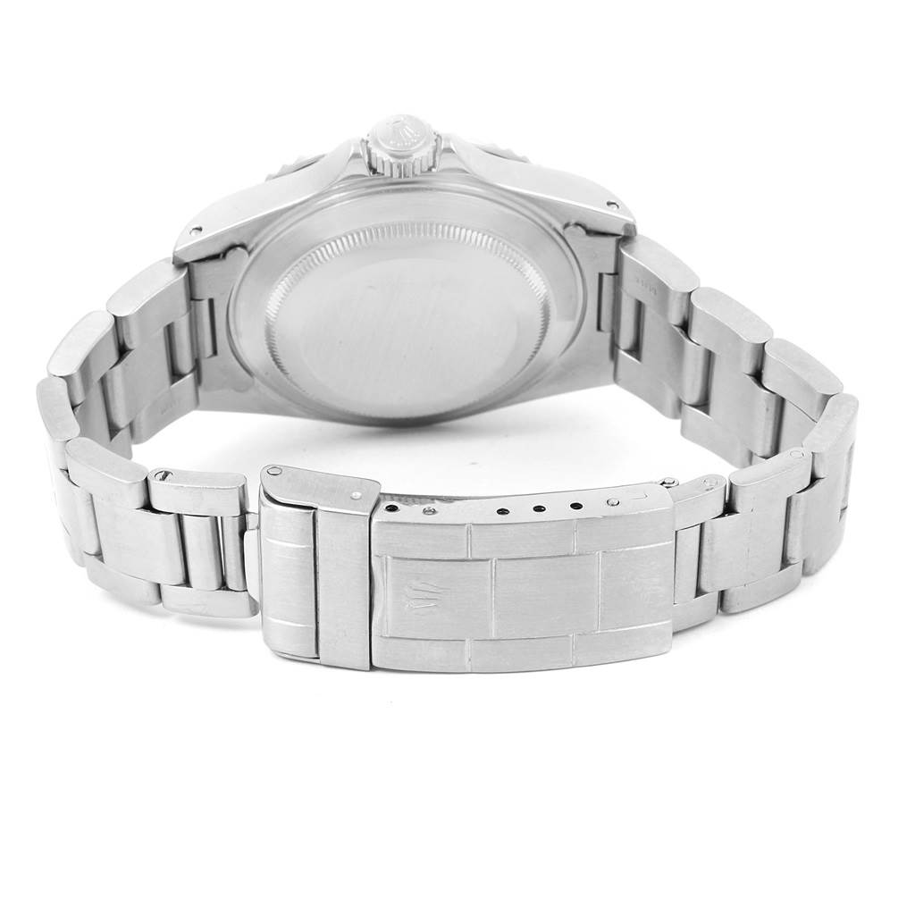 The image shows the back view of a Rolex Submariner 14060 Men
s Stainless Steel Black Dial 14060 Men
s Stainless Steel Black Dial watch, focusing on its case back and metal bracelet with clasp.