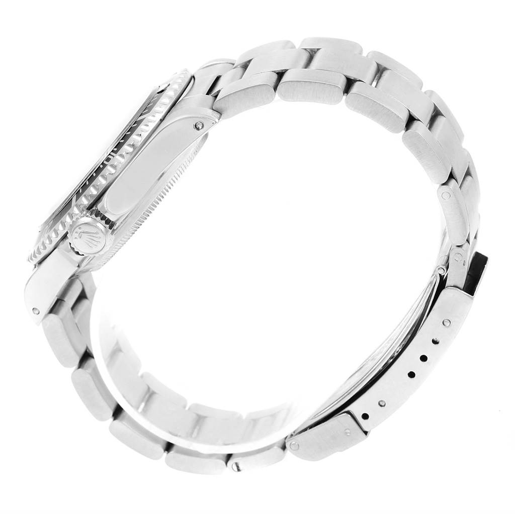 The image shows a side view of the Rolex Submariner 14060 Men
s Stainless Steel Black Dial 14060 Men
s Stainless Steel Black Dial watch, focusing on its bezel, crown, and metal bracelet.