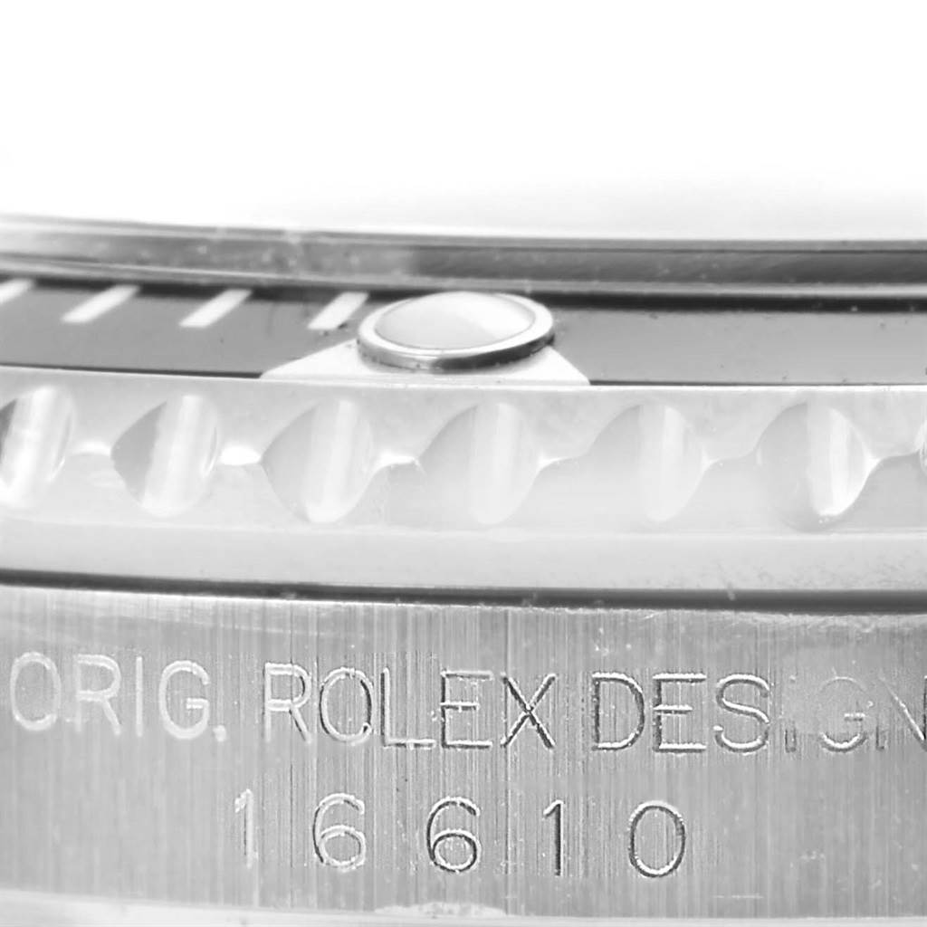 The image shows a close-up of the bezel and the engraved side of a Rolex Submariner 16610 Men's Stainless Steel Black Dial 16610 Men's Stainless Steel Black Dial 16610 watch.