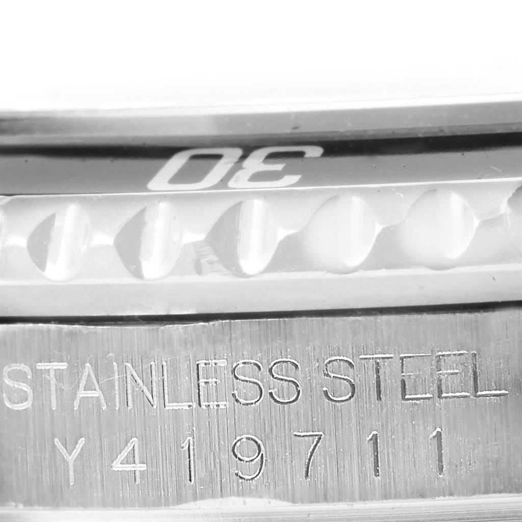 The image shows a close-up of the bezel and stainless steel case back with model details of a Rolex Submariner 16610 Men's Stainless Steel Black Dial 16610 Men's Stainless Steel Black Dial watch.