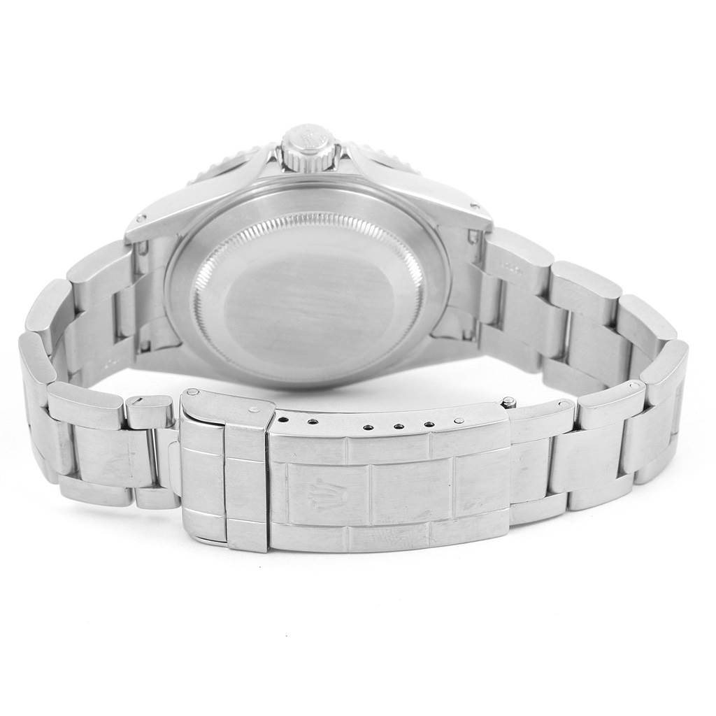 This Rolex Submariner 16610 Men's Stainless Steel Black Dial 16610 Men's Stainless Steel Black Dial watch is shown from the back, displaying its closed clasp and links of the metal bracelet.