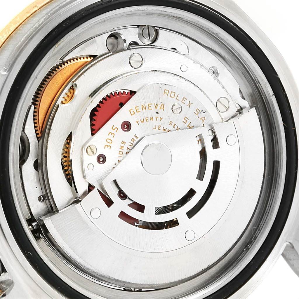 The image shows the inner mechanical movement of a Rolex Submariner 16803 Men
s Steel and Gold (two tone) Black Dial 16803 Men
s Steel and Gold (two tone) Black Dial watch, displaying gears and components.