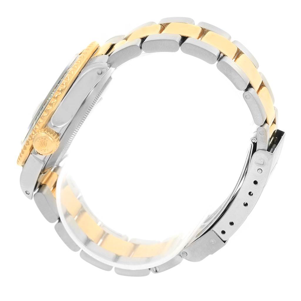 The image shows a side view of the bracelet and crown of the Rolex Submariner 16803 Men
s Steel and Gold (two tone) Black Dial 16803 Men
s Steel and Gold (two tone) Black Dial watch.