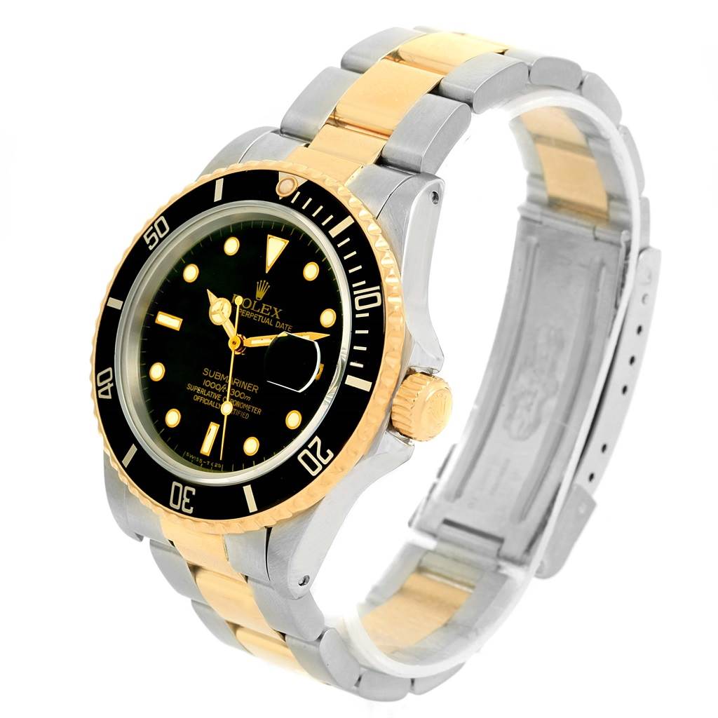 The image shows a Rolex Submariner 16803 Men
s Steel and Gold (two tone) Black Dial 16803 Men
s Steel and Gold (two tone) Black Dial watch at a three-quarter angle, highlighting its black dial, gold bezel, and two-tone bracelet.