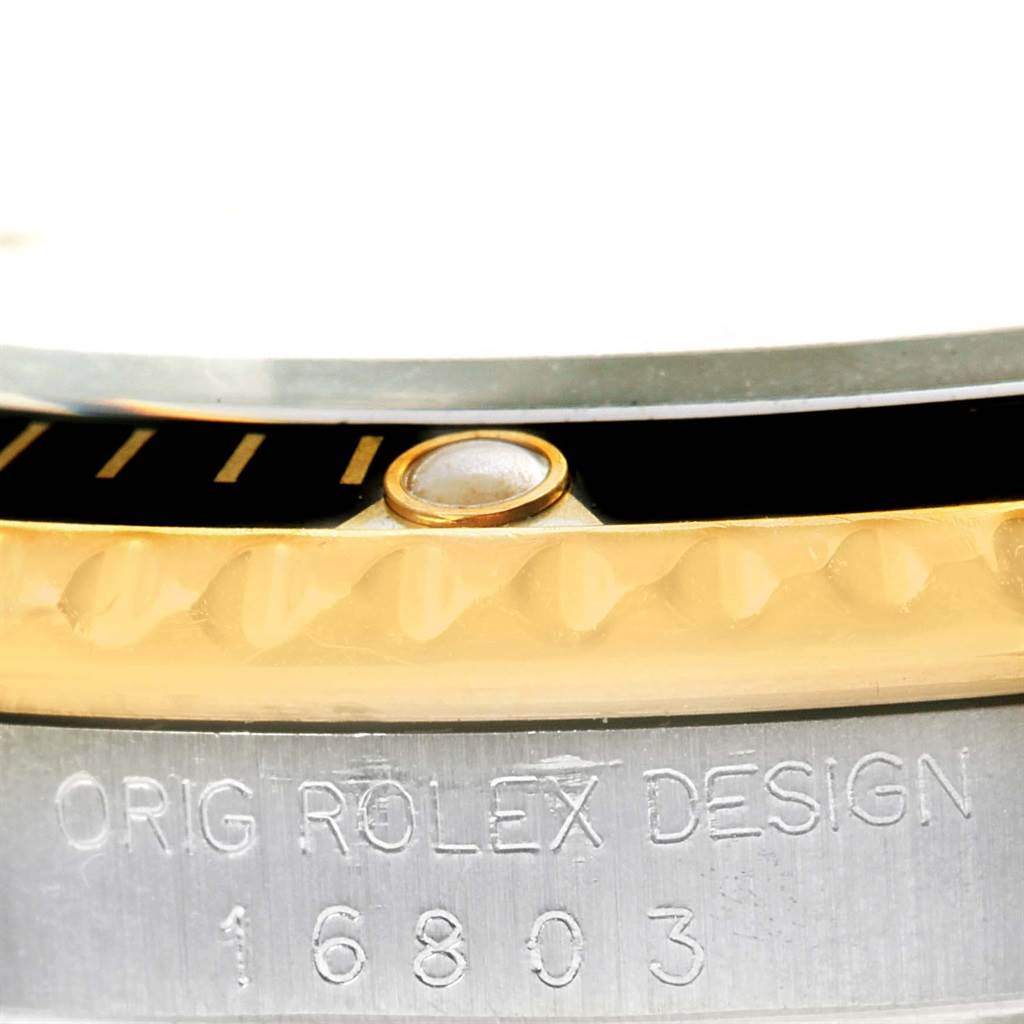 This close-up image shows the side view of the bezel and case edge of a Rolex Submariner 16803 Men
s Steel and Gold (two tone) Black Dial 16803 Men
s Steel and Gold (two tone) Black Dial, highlighting the model number 16803.