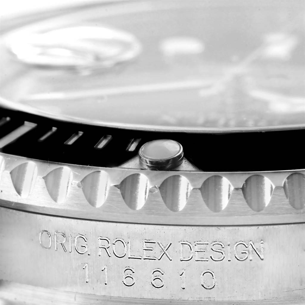 This close-up image shows the bezel and part of the case of a Rolex Submariner 116610 Men's Stainless Steel Black Dial 116610 Men's Stainless Steel Black Dial watch, including the "ORIG. ROLEX DESIGN" engraving.