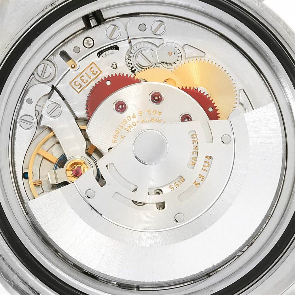 This image shows a close-up of the internal mechanism of a Rolex Submariner 116610LV Men's Stainless Steel Green Dial 116610LV Men's Stainless Steel Green Dial watch, including gears and the rotor.