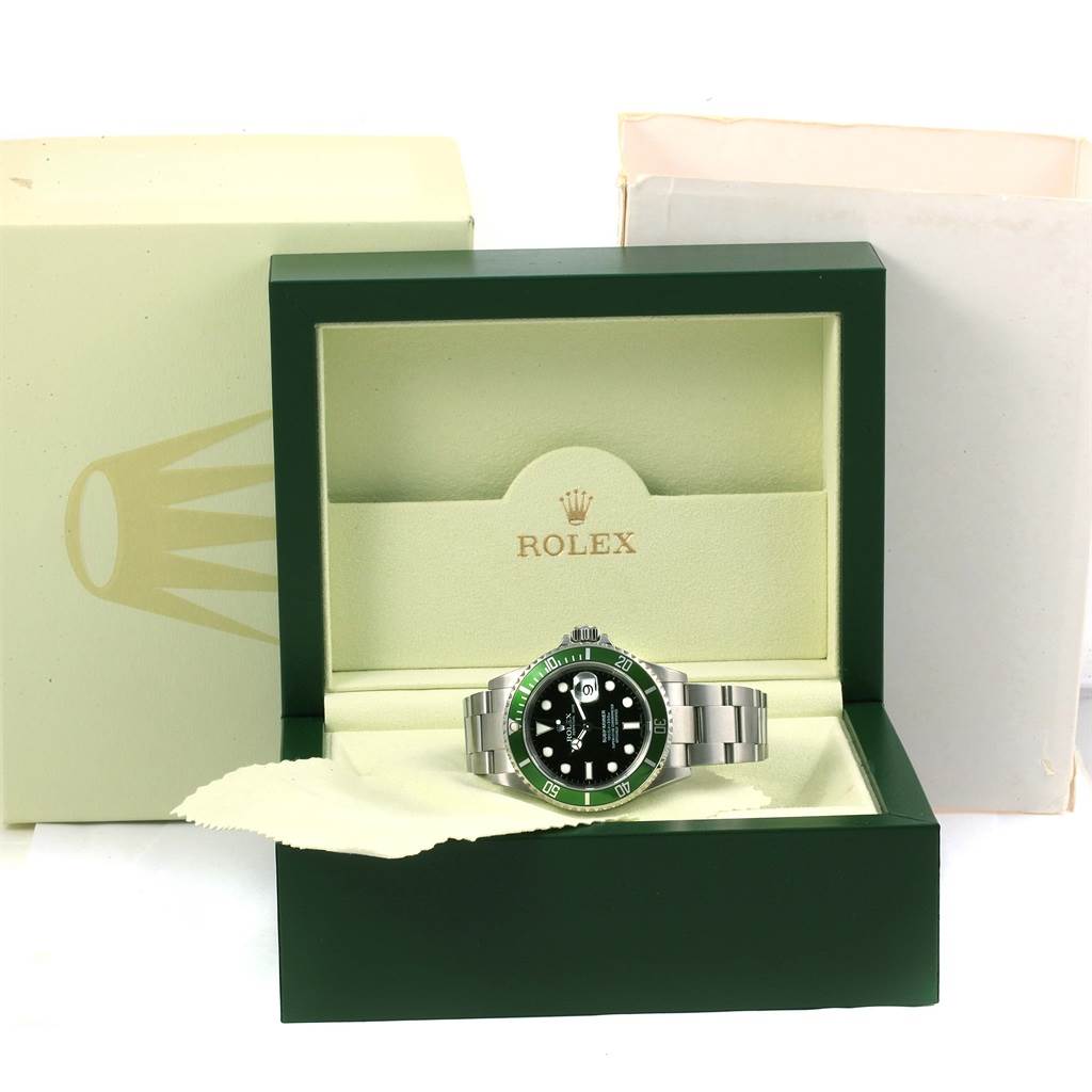 The Rolex Submariner 16610LV Men's Stainless Steel Black Dial 16610LV Men's Stainless Steel Black Dial watch is shown front-facing, placed inside its opened, branded box with outer packaging visible.