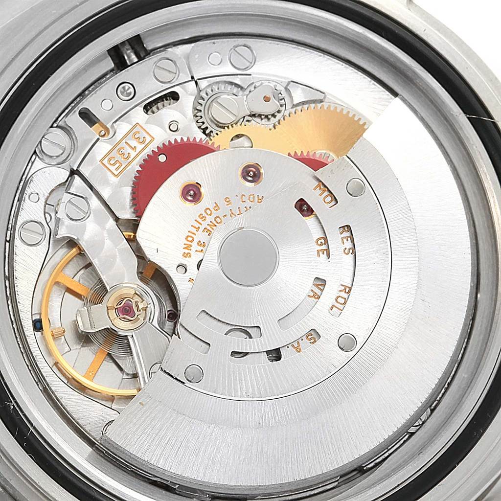 This image shows a detailed view of the movement and internal parts of a Rolex Submariner 16610 Men's Stainless Steel Black Dial 16610 Men's Stainless Steel Black Dial watch.