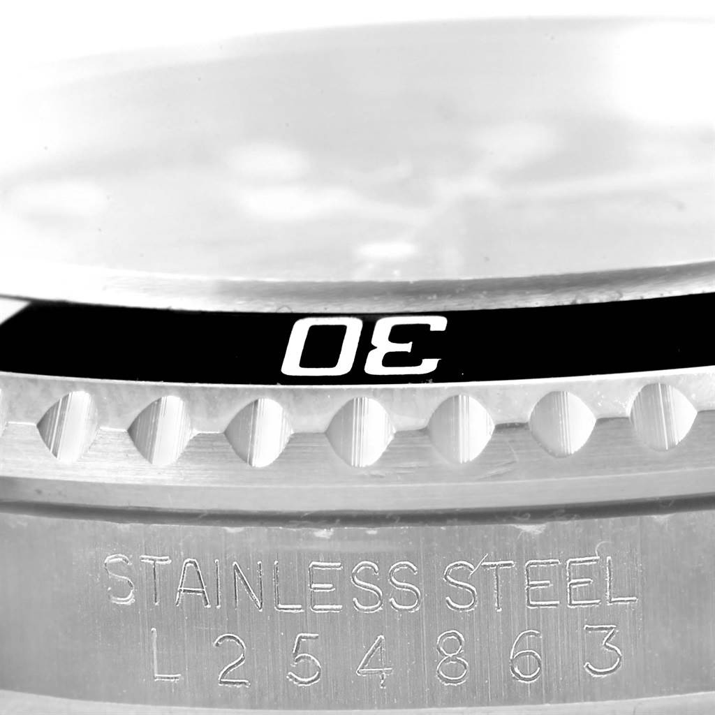 The image shows a close-up of the bezel and stainless steel case of a Rolex Submariner 16610 Men's Stainless Steel Black Dial 16610 Men's Stainless Steel Black Dial watch, highlighting the "30" marker and serial number engraving.