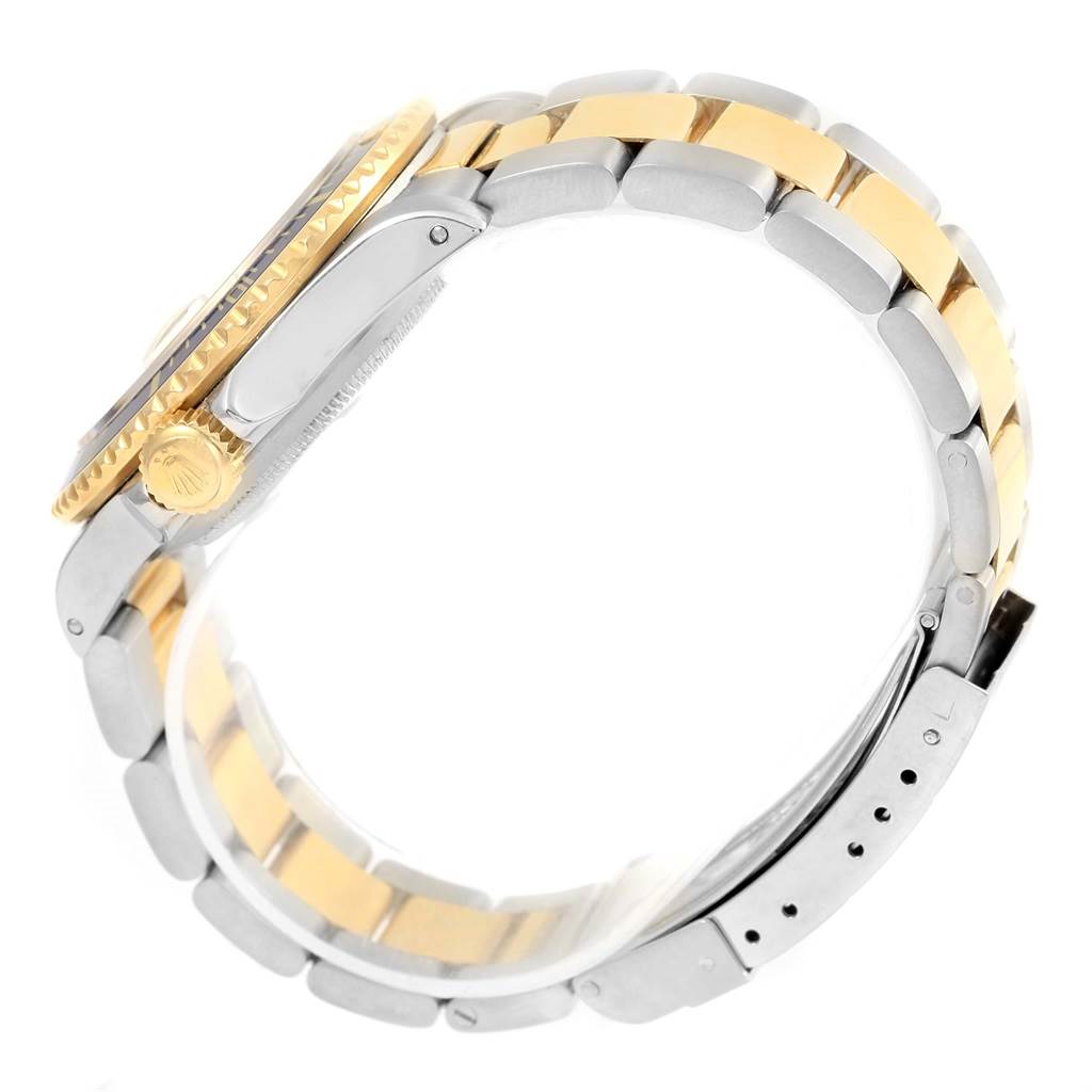 This image shows the side view of a Rolex Submariner 16803 Men's Steel and Gold (two tone) Blue Dial 16803 Men's Steel and Gold (two tone) Blue Dial watch, highlighting its gold bezel, crown, and two-tone bracelet.