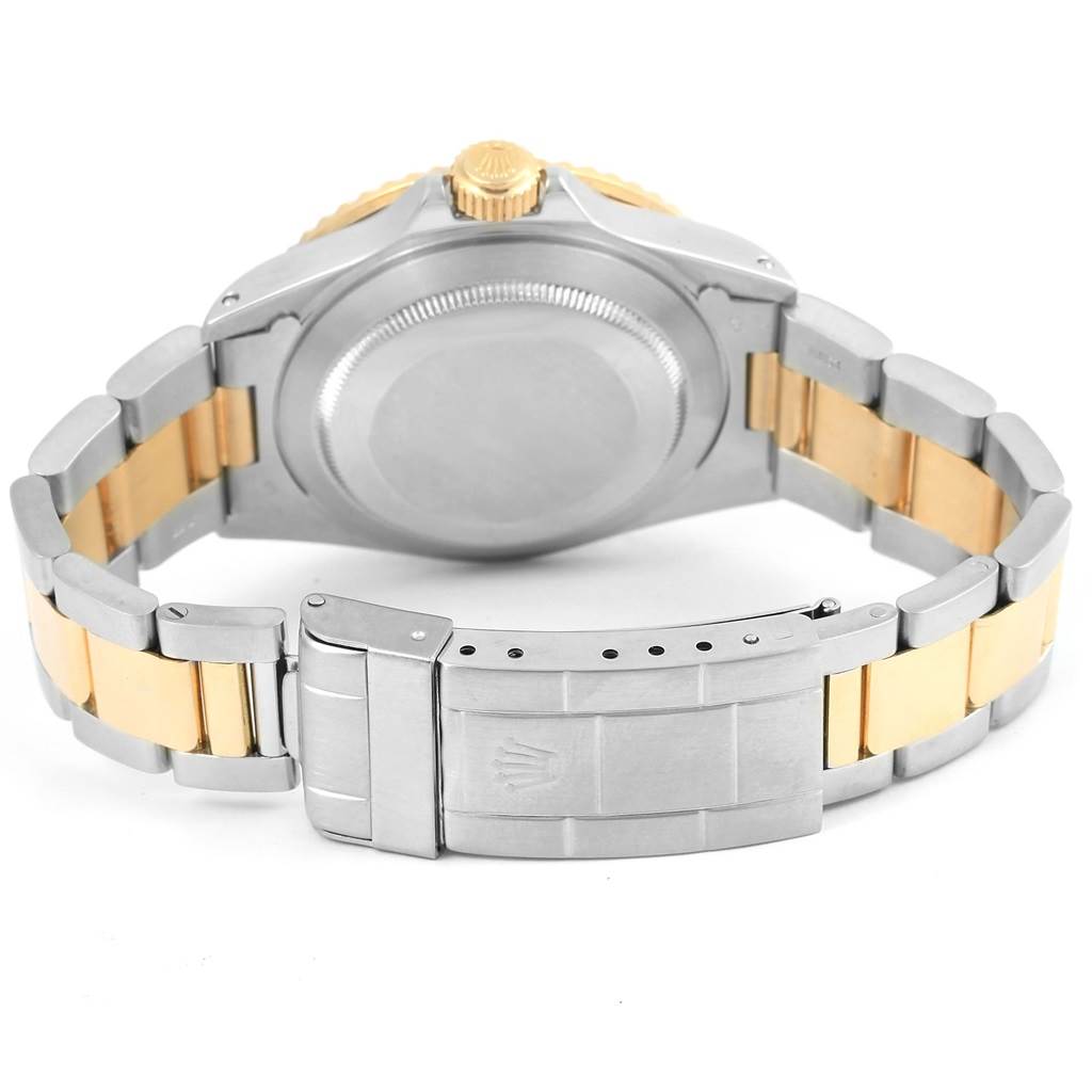 The image shows the back and clasp of a Rolex Submariner 16803 Men's Steel and Gold (two tone) Blue Dial 16803 Men's Steel and Gold (two tone) Blue Dial watch, highlighting the two-tone metal bracelet.