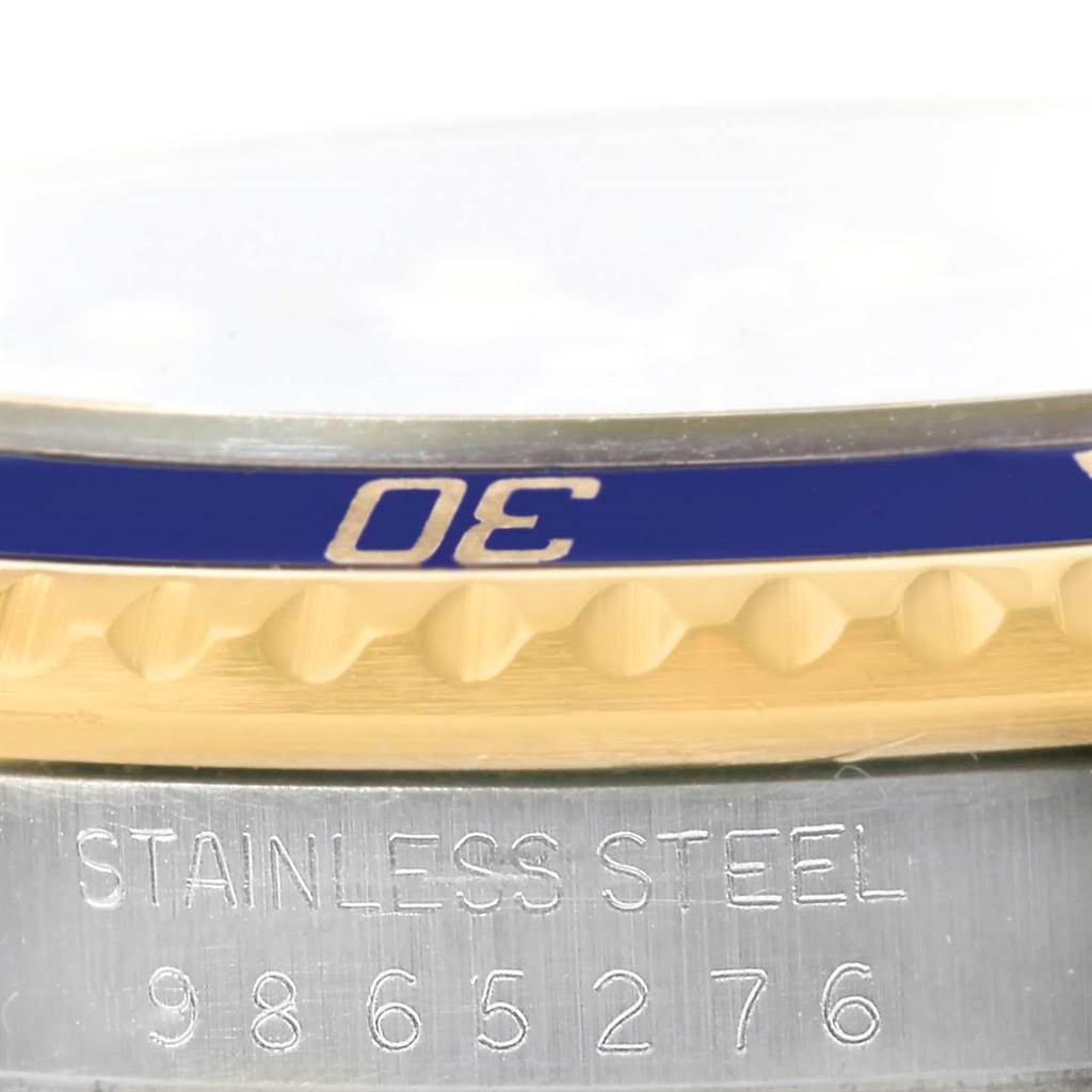 The image shows a close-up of the bezel and case of a Rolex Submariner 16803 Men's Steel and Gold (two tone) Blue Dial 16803 Men's Steel and Gold (two tone) Blue Dial watch, highlighting the "30" mark and serial number engraving.