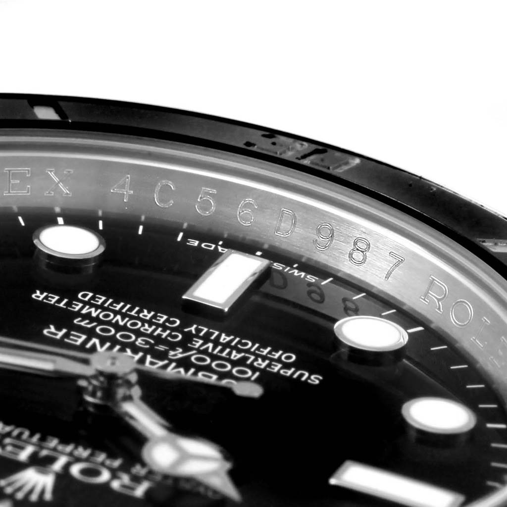 The image shows a close-up of the Rolex Submariner 116610 Men's Stainless Steel Black Dial 116610 Men's Stainless Steel Black Dial watch's dial and engraved inner bezel at an angled perspective.