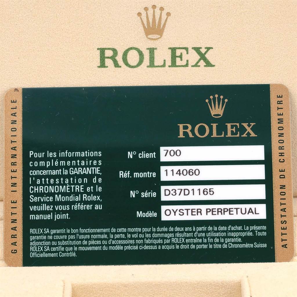 This image shows a warranty card for a Rolex Submariner 114060 Men's Stainless Steel Black Dial 114060 Men's Stainless Steel Black Dial model, featuring details like model and serial numbers.