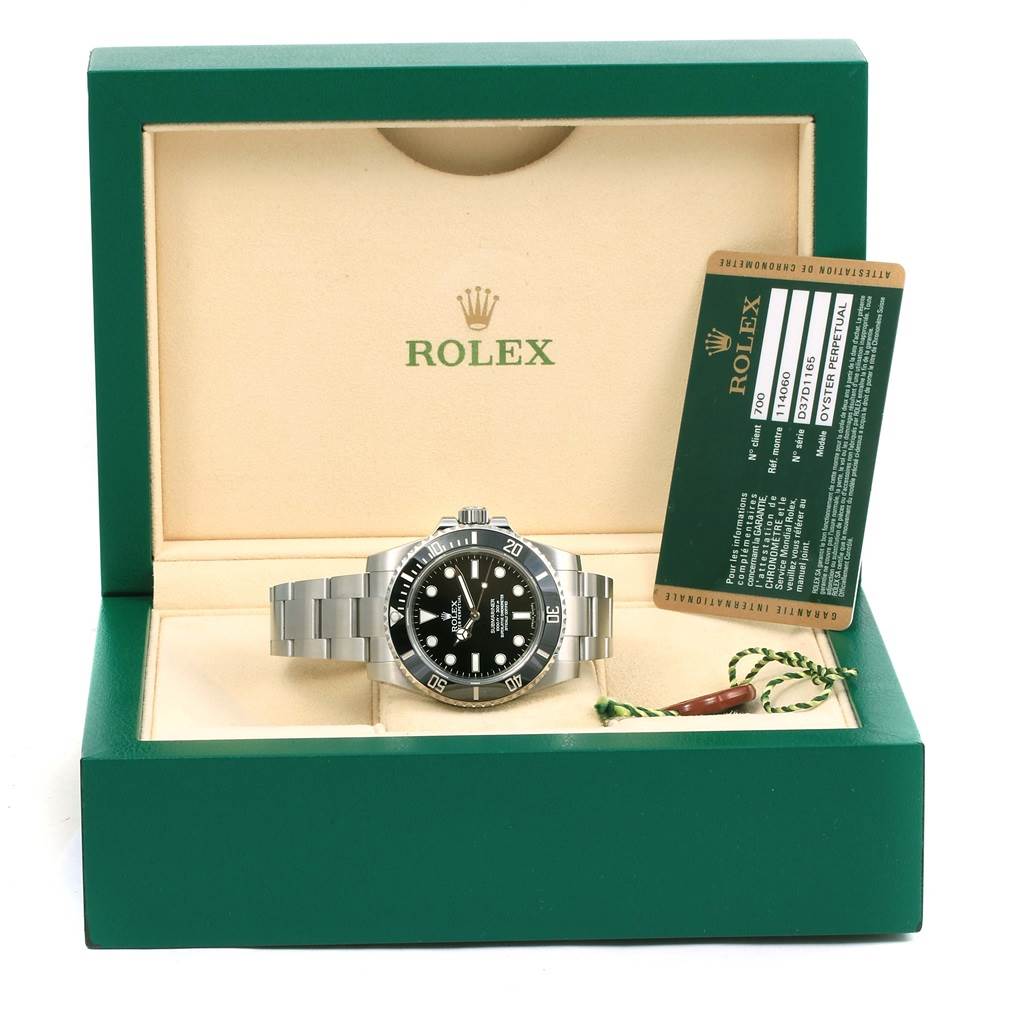 The image shows a front view of a Rolex Submariner 114060 Men's Stainless Steel Black Dial 114060 Men's Stainless Steel Black Dial watch in its open green box with its authenticity card beside it.