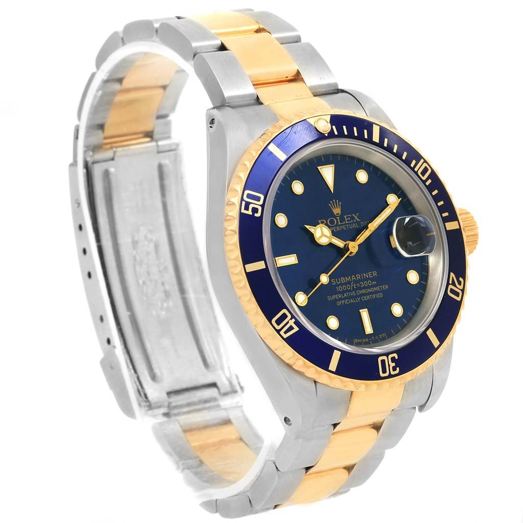 The Rolex Submariner 16613 Men
s Steel and Gold (two tone) Blue Dial 16613 Men
s Steel and Gold (two tone) Blue Dial watch is shown at an oblique angle, highlighting its bracelet, bezel, and face.
