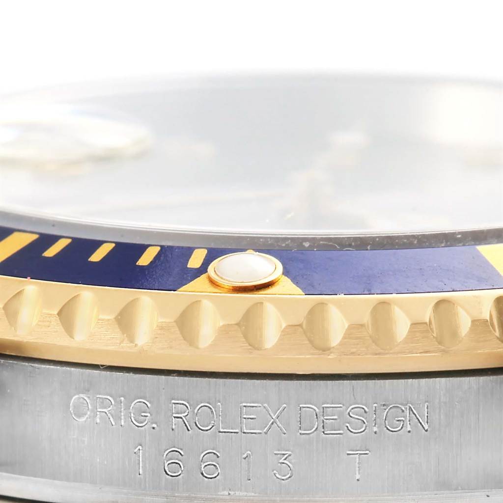 This image shows a close-up of the bezel, crystal, and case engraving of the Rolex Submariner 16613 Men
s Steel and Gold (two tone) Grey Dial 16613 Men
s Steel and Gold (two tone) Grey Dial model 16613.