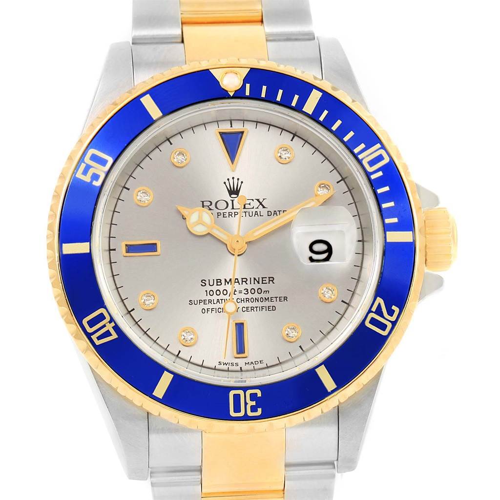 This image shows a frontal view of a Rolex Submariner 16613 Men
s Steel and Gold (two tone) Grey Dial 16613 Men
s Steel and Gold (two tone) Grey Dial watch featuring a blue bezel, silver dial, and two-tone metal bracelet.