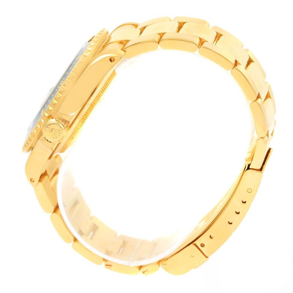 The image shows a side view of a Rolex Submariner 16618 Men's Yellow Gold Blue Dial 16618 Men's Yellow Gold Blue Dial watch, clearly displaying the gold bracelet, crown, and part of the case.