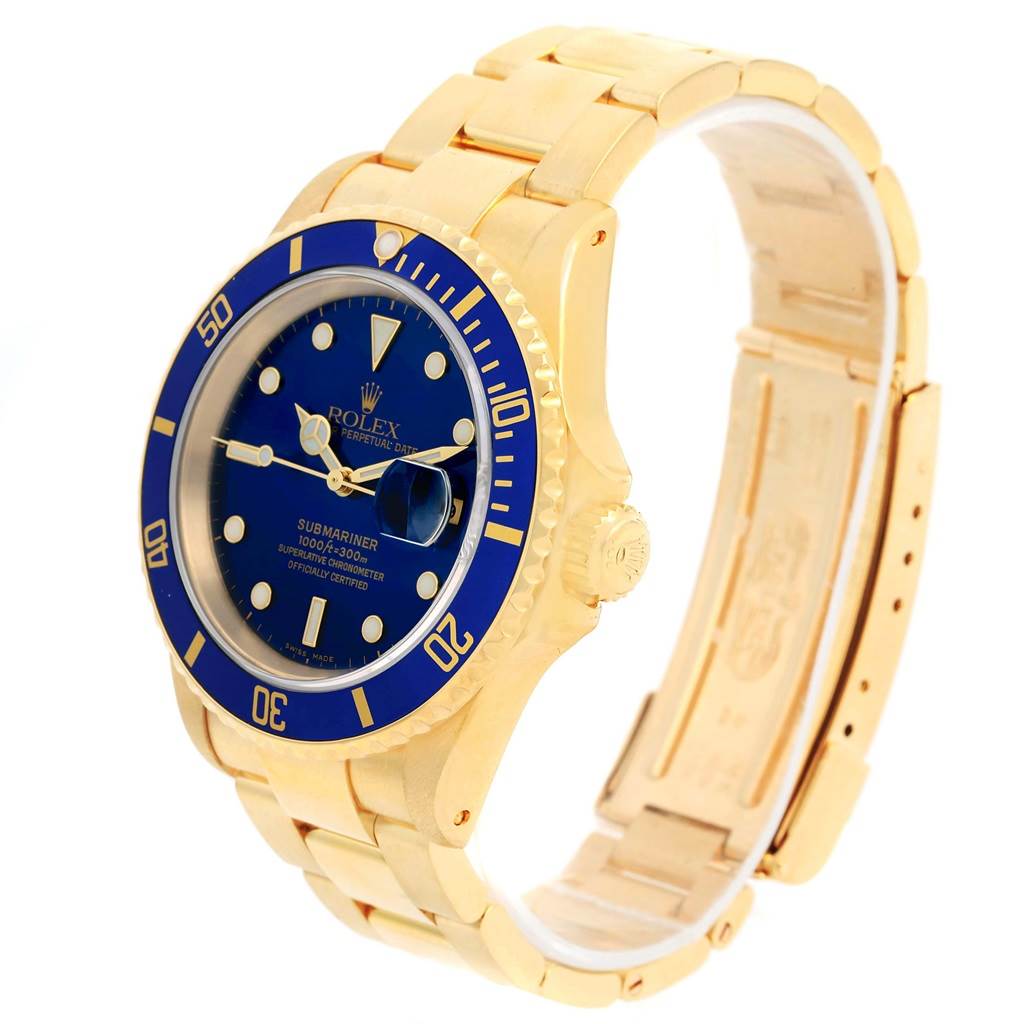 This Rolex Submariner 16618 Men's Yellow Gold Blue Dial 16618 Men's Yellow Gold Blue Dial watch is shown at a front-side angle, displaying its blue dial, bezel, and gold bracelet.
