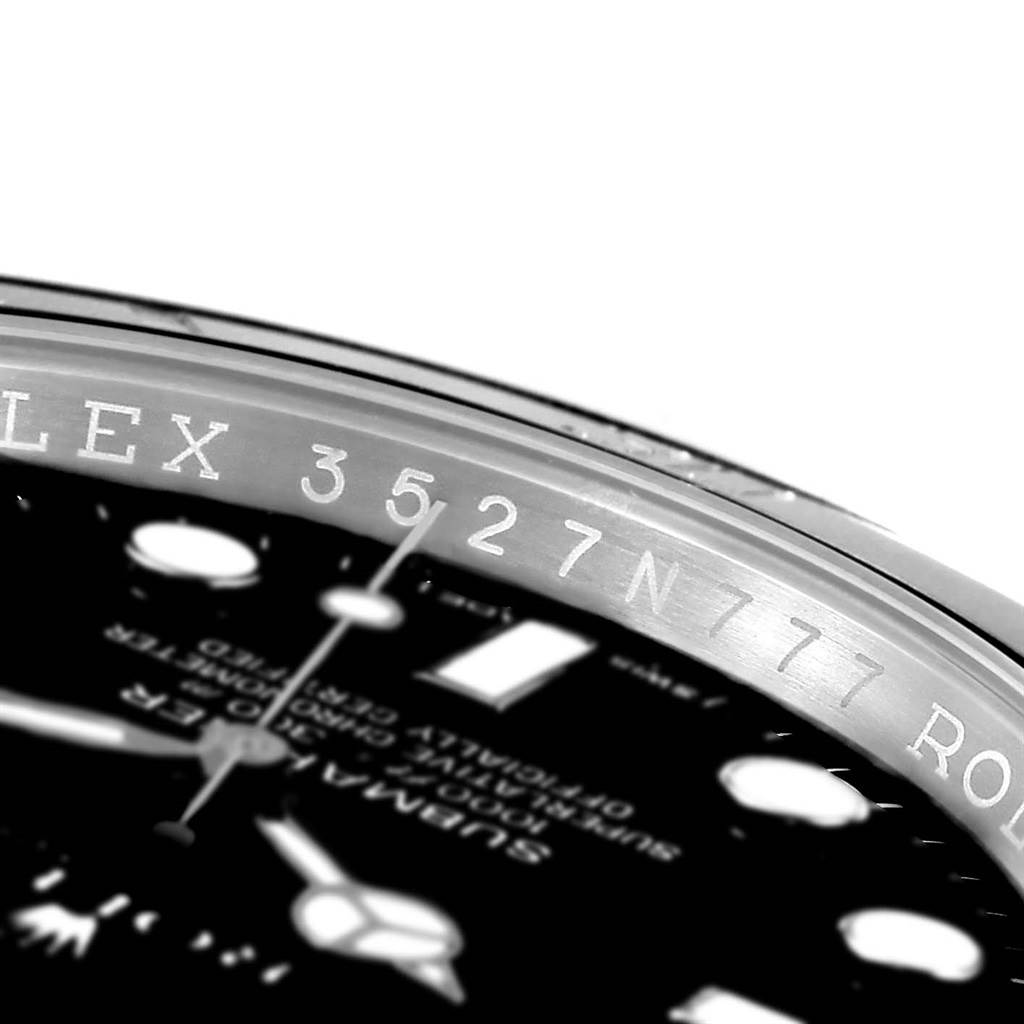 This is a close-up angle showing the dial and part of the bezel of a Rolex Submariner 116610 Men's Stainless Steel Black Dial 116610 Men's Stainless Steel Black Dial watch, along with the engraved serial number.