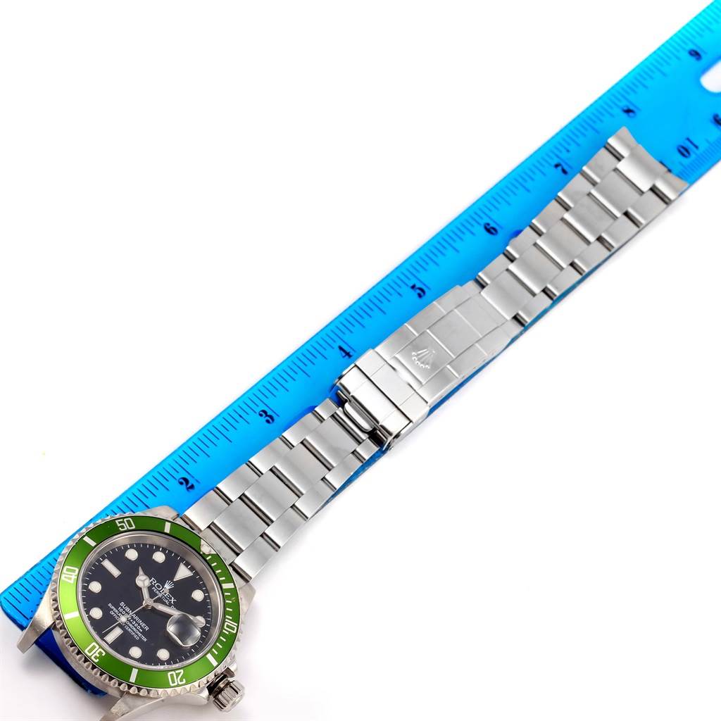 The image shows a horizontal view of the Rolex Submariner 16610LV Men's Stainless Steel Black Dial 16610LV Men's Stainless Steel Black Dial watch with the bracelet fully extended next to a ruler for measurement.