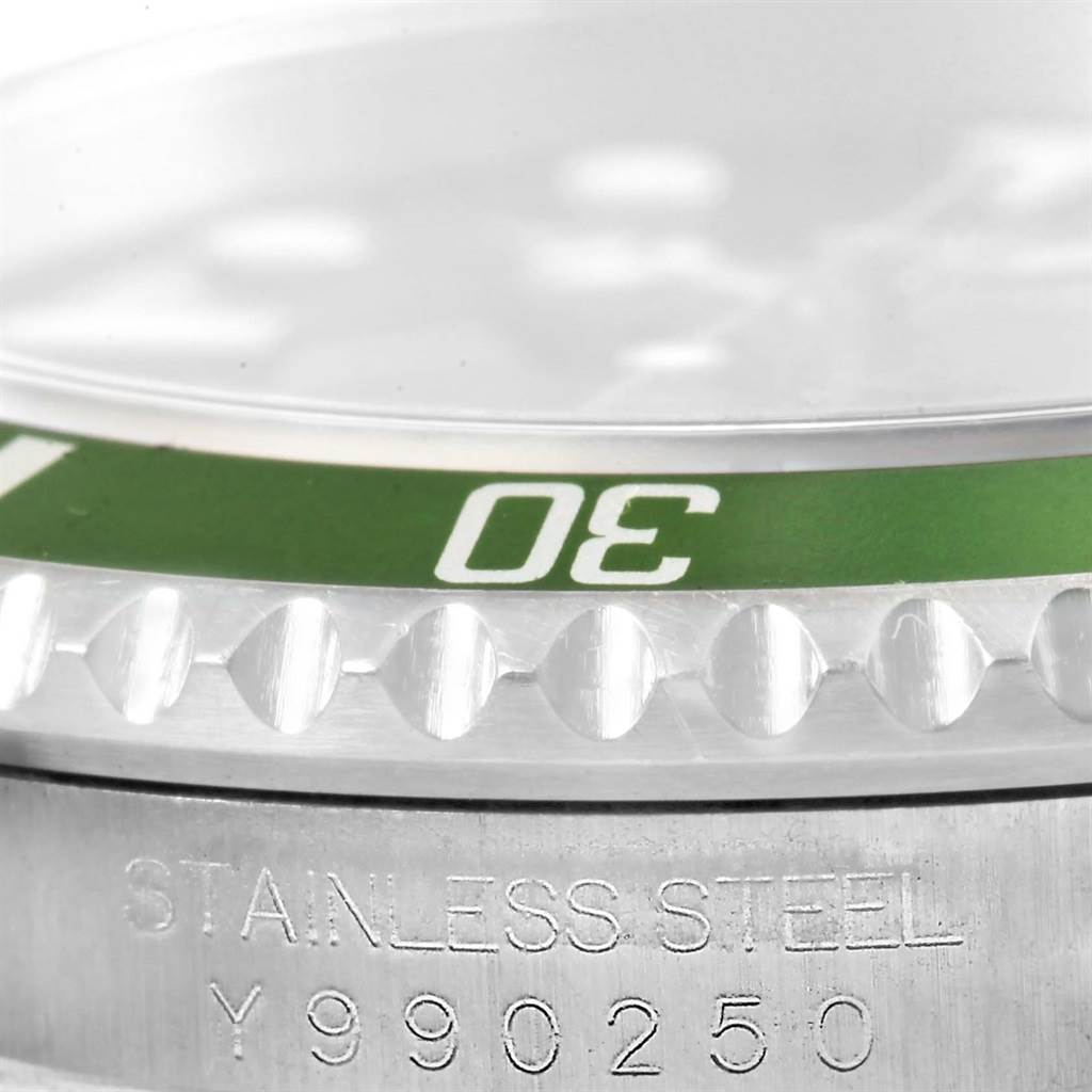 The image shows a close-up of the bezel and part of the stainless steel casing with engravings on the Rolex Submariner 16610LV Men's Stainless Steel Black Dial 16610LV Men's Stainless Steel Black Dial watch.