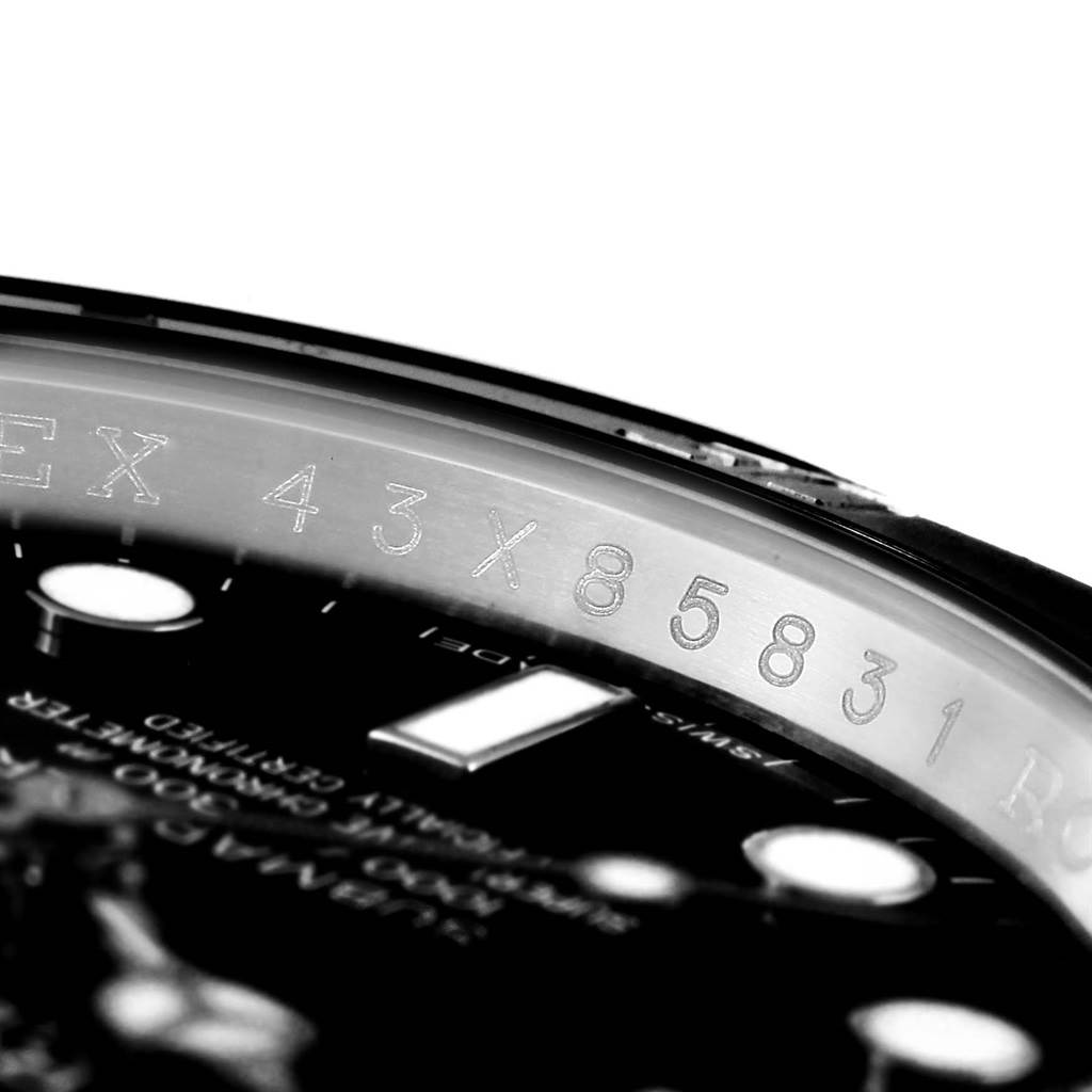 The image shows a close-up of the serial number engraving on the inner bezel of a Rolex Submariner 114060 Men's Stainless Steel Black Dial 114060 Men's Stainless Steel Black Dial watch.
