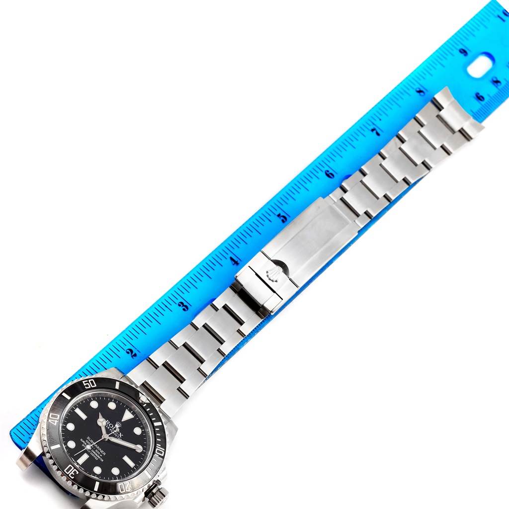 The image shows a Rolex Submariner 114060 Men's Stainless Steel Black Dial 114060 Men's Stainless Steel Black Dial watch laid out flat, with the bracelet unclasped next to a blue ruler for measurement.