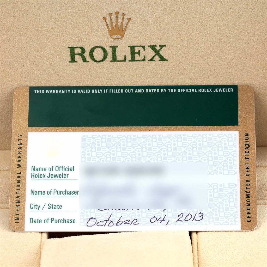 The image shows an international warranty card for the Rolex Submariner 114060 Men's Stainless Steel Black Dial 114060 Men's Stainless Steel Black Dial, placed in a beige case with the Rolex logo.