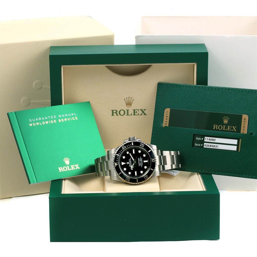 This image shows a Rolex Submariner 114060 Men's Stainless Steel Black Dial 114060 Men's Stainless Steel Black Dial watch displayed in its open box along with a guarantee manual and warranty card.
