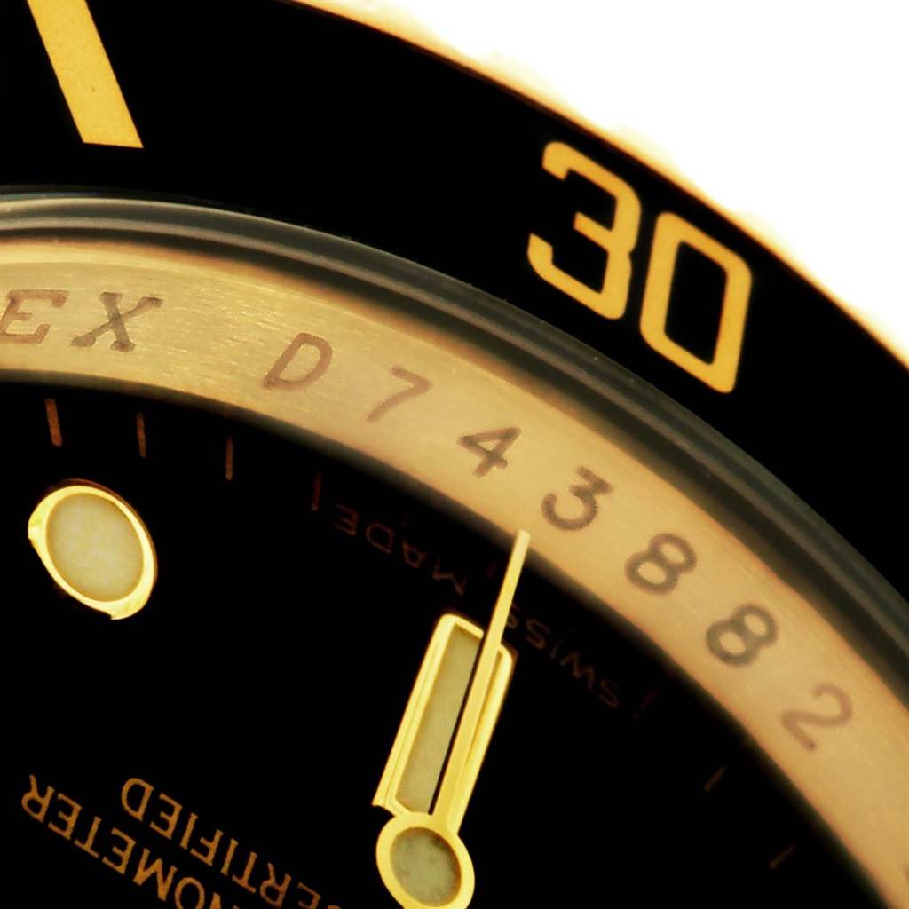 This close-up shows the dial and bezel, including the 30-second mark, of a Rolex Submariner 16618 Men's Yellow Gold Black Dial 16618 Men's Yellow Gold Black Dial watch.