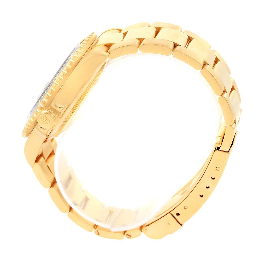 This side angle shows the band, side profile of the case, and crown of the Rolex Submariner 16618 Men's Yellow Gold Black Dial 16618 Men's Yellow Gold Black Dial watch.