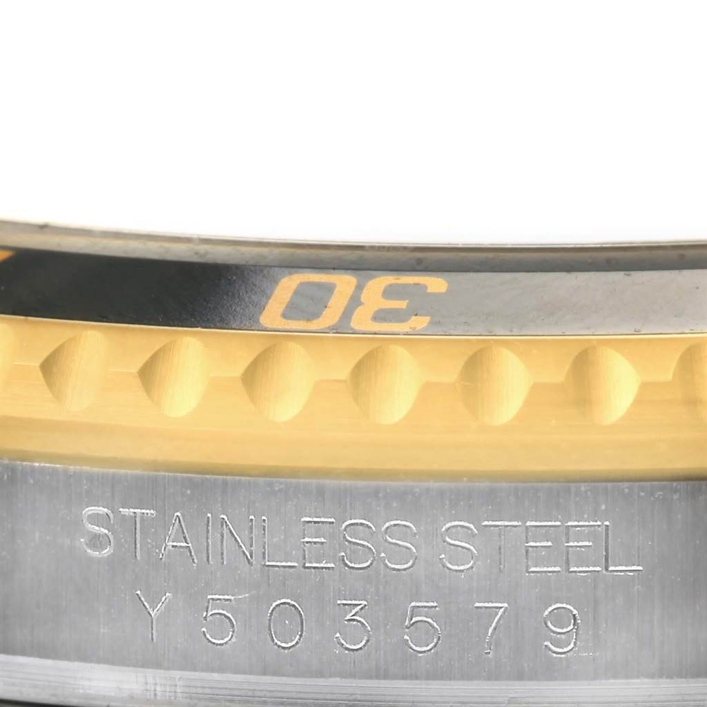 The image shows a close-up of the bezel and case along with the serial number of the Rolex Submariner 16613 Men's Steel and Gold (two tone) Champagne Dial 16613 Men's Steel and Gold (two tone) Champagne Dial watch.