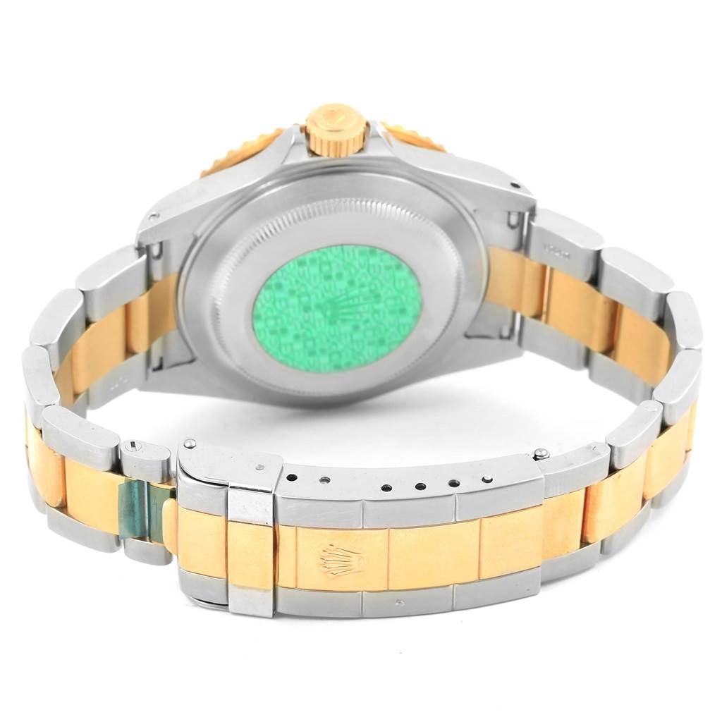 This image shows the backside and bracelet of a Rolex Submariner 16613 Men's Steel and Gold (two tone) Champagne Dial 16613 Men's Steel and Gold (two tone) Champagne Dial watch at a partial rear view angle.