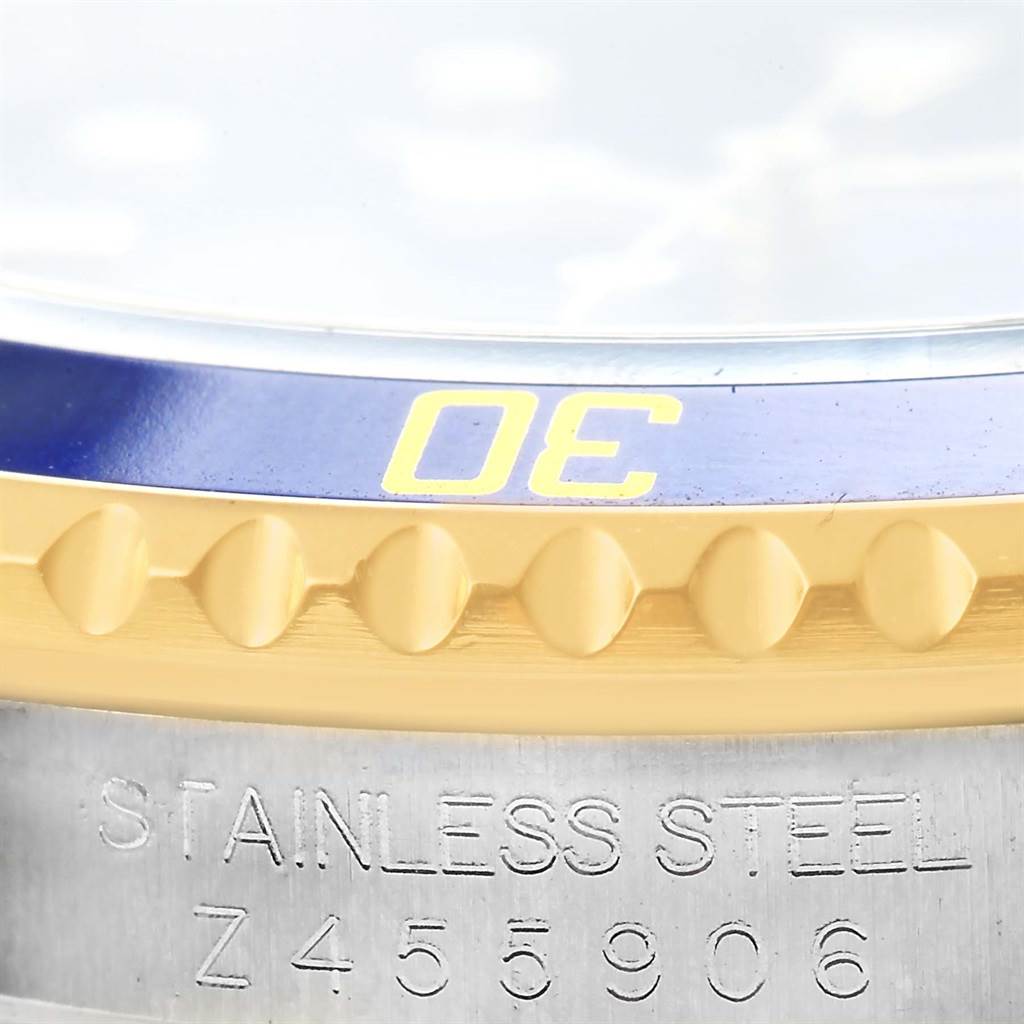 This close-up image shows the side of the bezel and the engraved stainless steel part of the Rolex Submariner 16613 Men's Steel and Gold (two tone) Blue Dial 16613 Men's Steel and Gold (two tone) Blue Dial watch case.
