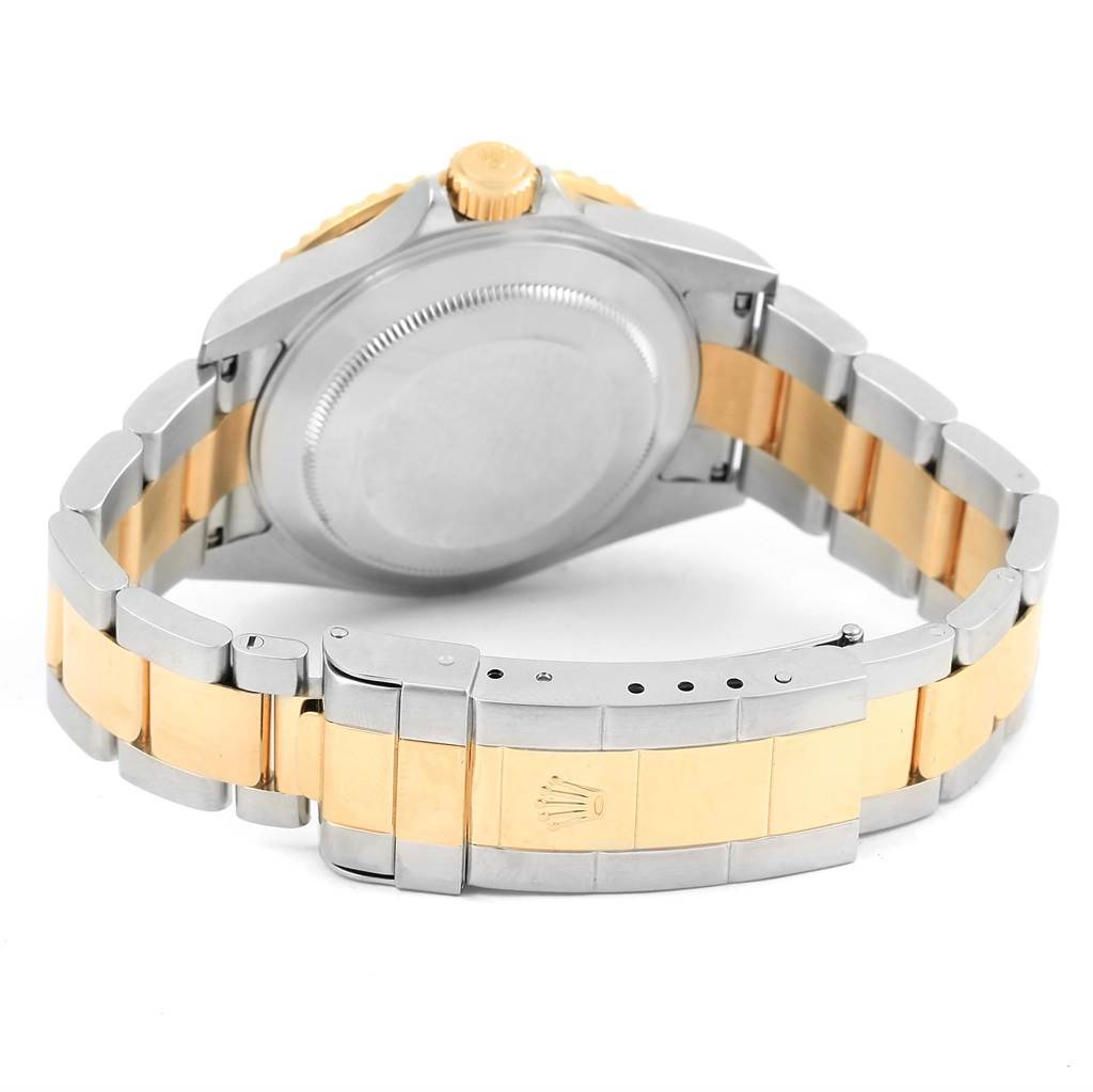 The image shows the back and bracelet of a Rolex Submariner 16613 Men's Steel and Gold (two tone) Blue Dial 16613 Men's Steel and Gold (two tone) Blue Dial watch, highlighting its two-tone metal design and clasp.